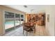 Bright eat-in kitchen features wood cabinets, tiled floors, a sliding door to the pool, and stainless steel appliances at 13821 Joyce Dr, Largo, FL 33774
