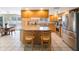 Spacious eat-in kitchen with wood cabinets, island with bar stool seating, and stainless steel appliances at 13821 Joyce Dr, Largo, FL 33774