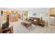Cozy living room area connecting to an open floorplan and kitchen, perfect for modern living at 13821 Joyce Dr, Largo, FL 33774