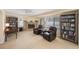 Comfortable living space features built-in bookshelves, a brick fireplace, and large windows at 13821 Joyce Dr, Largo, FL 33774