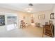 Spacious living area transitioning to dining with sliding doors to the outdoor pool area at 13821 Joyce Dr, Largo, FL 33774