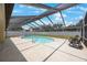 Inviting backyard pool under a screened enclosure, perfect for relaxation at 13821 Joyce Dr, Largo, FL 33774