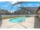 Inviting backyard pool with screened enclosure, and ladder for easy access at 13821 Joyce Dr, Largo, FL 33774