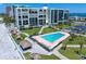 Aerial view of beachfront condo with a pool, landscaped grounds, and beach access at 1400 Gulf Blvd # 804, Clearwater Beach, FL 33767
