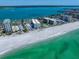 Stunning aerial view of beachfront condos with pristine white sand and sparkling turquoise water at 1400 Gulf Blvd # 804, Clearwater Beach, FL 33767