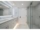Modern bathroom features double vanity, shower with glass door, and marble floors at 1400 Gulf Blvd # 804, Clearwater Beach, FL 33767