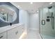 Modern bathroom features a glass-enclosed shower and a vanity with a sleek countertop and decorative mirror at 1400 Gulf Blvd # 804, Clearwater Beach, FL 33767