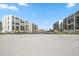 Beach view with multiple beachfront condos, thatched umbrellas and white sand at 1400 Gulf Blvd # 804, Clearwater Beach, FL 33767