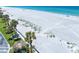 Aerial view of white sand beach with tiki huts and palm trees near beachfront condo at 1400 Gulf Blvd # 804, Clearwater Beach, FL 33767