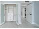 Walk-in closet with custom shelving and glass doors, next to a laundry room at 1400 Gulf Blvd # 804, Clearwater Beach, FL 33767