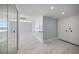 Hallway and adjoining room with marble floors and recessed lighting leading to kitchen at 1400 Gulf Blvd # 804, Clearwater Beach, FL 33767
