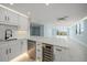 A spacious kitchen boasts stainless steel appliances, a beverage cooler, and an island with a counter at 1400 Gulf Blvd # 804, Clearwater Beach, FL 33767