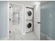 Conveniently located laundry area with stacked washer and dryer, in a hallway featuring marble tile flooring at 1400 Gulf Blvd # 804, Clearwater Beach, FL 33767