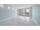 Bright living room features light blue walls, marble floors and sliding glass doors to balcony overlooking city views at 1400 Gulf Blvd # 804, Clearwater Beach, FL 33767
