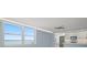 Living room and kitchen area featuring windows, blue walls, and stainless steel appliances at 1400 Gulf Blvd # 804, Clearwater Beach, FL 33767