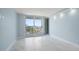 Bright living room features light blue walls, marble floors and sliding glass doors to balcony overlooking water views at 1400 Gulf Blvd # 804, Clearwater Beach, FL 33767