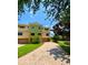 Elegant townhome showcasing a well-manicured lawn and brick driveway leading to a spacious two-car garage at 1503 Citrine Trl, Tarpon Springs, FL 34689
