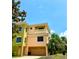 Stylish townhome with a private balcony, two-car garage, complemented by lush tropical landscaping at 1503 Citrine Trl, Tarpon Springs, FL 34689