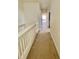 Well-lit hallway with neutral paint and carpet providing access to different rooms at 1503 Citrine Trl, Tarpon Springs, FL 34689