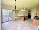 Bright kitchen featuring tile floors, center island and black appliances, perfect for cooking and entertaining at 1503 Citrine Trl, Tarpon Springs, FL 34689