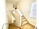 Carpeted staircase with white railings leading to the upper level of the home at 1503 Citrine Trl, Tarpon Springs, FL 34689