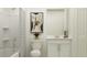 Cozy bathroom featuring a shower with tub, single sink vanity with white cabinets and neutral paint color at 15045 Zircon Red Dr, Wimauma, FL 33598