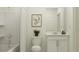 Cozy bathroom featuring a shower with tub, single sink vanity with white cabinets and neutral paint color at 15045 Zircon Red Dr, Wimauma, FL 33598