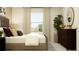 Well-lit bedroom featuring a comfortable bed, dark dresser, and lots of natural light from a large window at 15045 Zircon Red Dr, Wimauma, FL 33598
