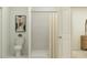 Clean bathroom showcases a shower with tile surround, a toilet, and a framed art print at 15091 Zircon Red Dr, Wimauma, FL 33598