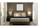 A cozy bedroom featuring a stylish bed with decorative pillows and a baseball art piece at 15091 Zircon Red Dr, Wimauma, FL 33598