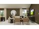 Stylish living room features neutral tones, comfortable seating, and a view of the outdoors at 15091 Zircon Red Dr, Wimauma, FL 33598