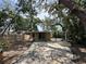 Spacious backyard featuring a large patio, wooden fence, and mature trees providing shade at 1536 S Martin Luther King Jr Ave, Clearwater, FL 33756