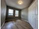 Bedroom with two windows, wood-look floors, and a closet at 1536 S Martin Luther King Jr Ave, Clearwater, FL 33756