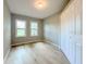 Comfortable bedroom with a closet, wood-look floor, neutral walls and natural lighting at 1536 S Martin Luther King Jr Ave, Clearwater, FL 33756