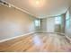 Large bonus room with wood-look laminate flooring, natural light and a white door at 1536 S Martin Luther King Jr Ave, Clearwater, FL 33756
