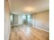 Large bonus room with wood-look laminate flooring, natural light and a white door at 1536 S Martin Luther King Jr Ave, Clearwater, FL 33756
