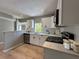 Bright kitchen with white cabinets, stainless steel appliances, and white subway tile backsplash at 1536 S Martin Luther King Jr Ave, Clearwater, FL 33756
