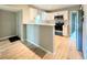 Updated kitchen with sleek countertops, modern appliances, a breakfast bar and wood-look floors at 1536 S Martin Luther King Jr Ave, Clearwater, FL 33756