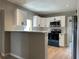 Modern kitchen featuring white cabinets, stainless steel appliances, and new floors at 1536 S Martin Luther King Jr Ave, Clearwater, FL 33756