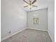 Bedroom featuring neutral gray carpet, one window and a ceiling fan at 16866 Balance Cv, Land O Lakes, FL 34638