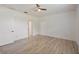 A bright and spacious bedroom features a ceiling fan and light wood-look floors at 16866 Balance Cv, Land O Lakes, FL 34638