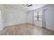Bedroom with hardwood floors and ample natural light from the window at 16866 Balance Cv, Land O Lakes, FL 34638
