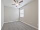 A neutral bedroom with gray carpet, one window, and a ceiling fan at 16866 Balance Cv, Land O Lakes, FL 34638