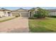 Charming townhome with well-manicured lawn and brick paver driveway at 16866 Balance Cv, Land O Lakes, FL 34638