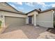 Attractive home featuring a two-car garage and a welcoming entryway at 16866 Balance Cv, Land O Lakes, FL 34638