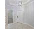 Bright entryway with tiled floors and a modern light fixture at 16866 Balance Cv, Land O Lakes, FL 34638