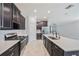 Kitchen featuring granite counters, an island, and dark wood cabinets at 16866 Balance Cv, Land O Lakes, FL 34638