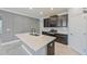 Beautiful kitchen island featuring dark cabinets and stylish pendant lighting at 16866 Balance Cv, Land O Lakes, FL 34638