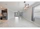Open-concept living space with tiled floors and abundant natural light at 16866 Balance Cv, Land O Lakes, FL 34638