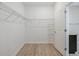 A walk-in closet featuring wire shelving and light wood-look floors at 16866 Balance Cv, Land O Lakes, FL 34638